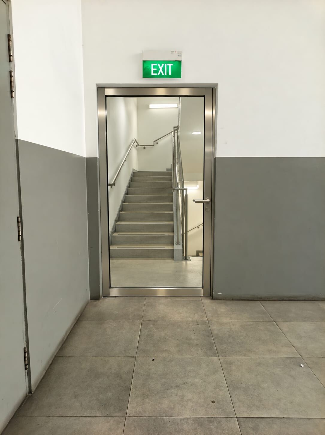 After: fire rated glass exit door showing the staircase